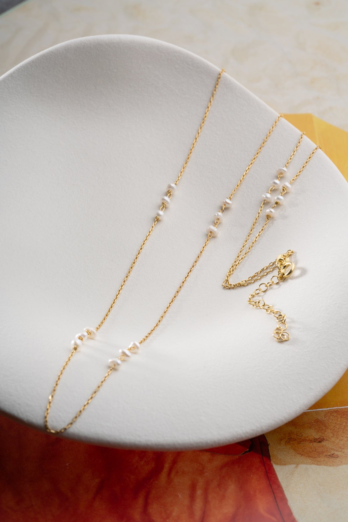 Long Pearl Station Necklace in Gold