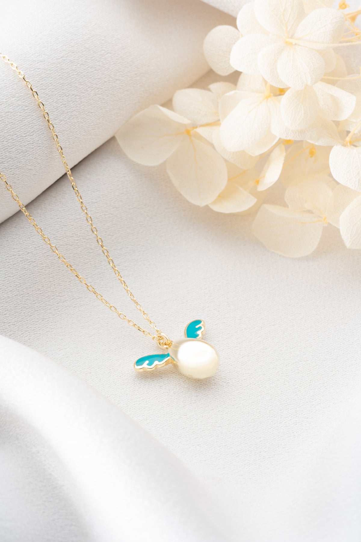 Pearl Egg Necklace with Turquoise Enamel Wings