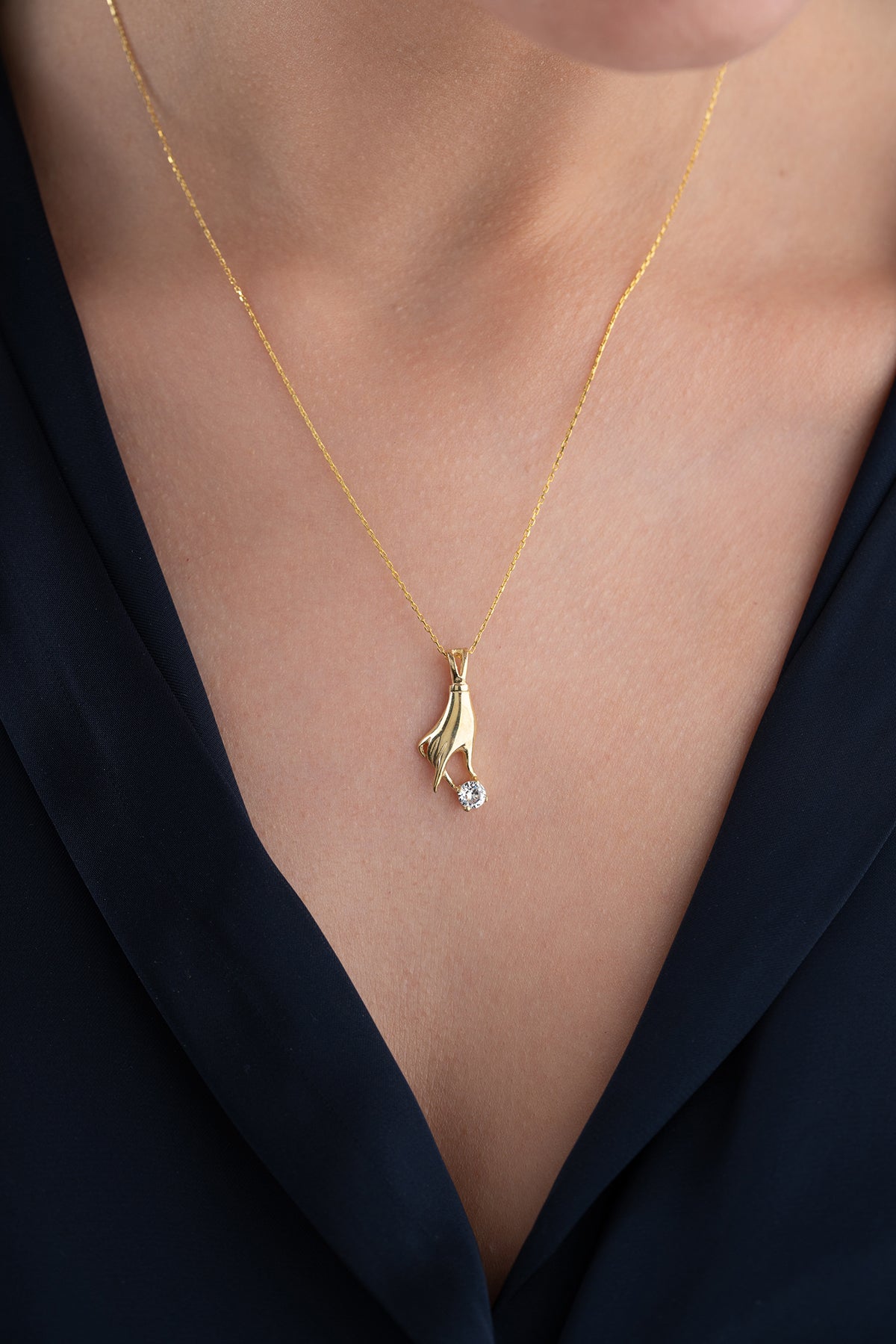 Hand Holding Stone Pendant Necklace