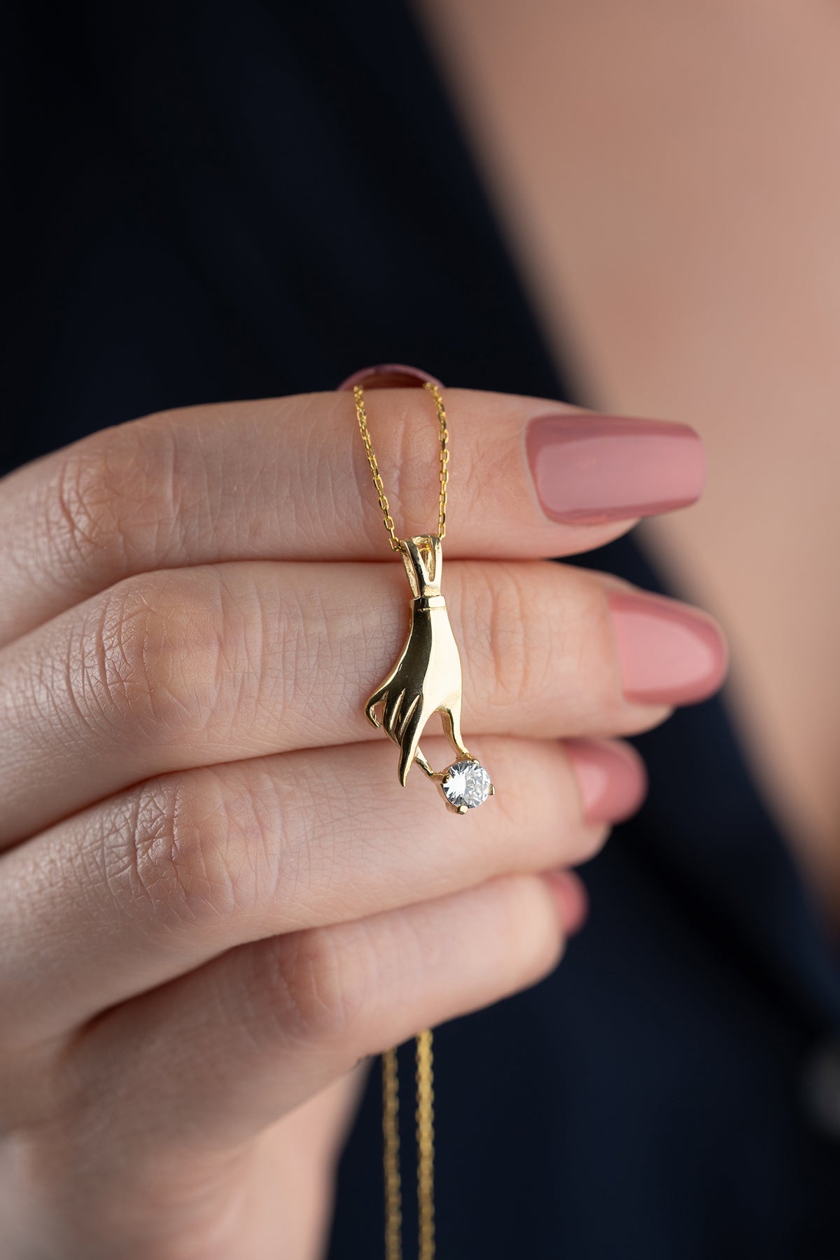 Hand Holding Stone Pendant Necklace