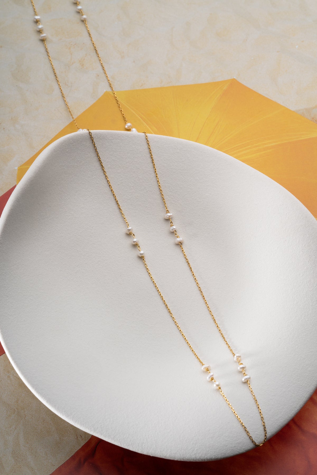 Long Pearl Station Necklace in Gold