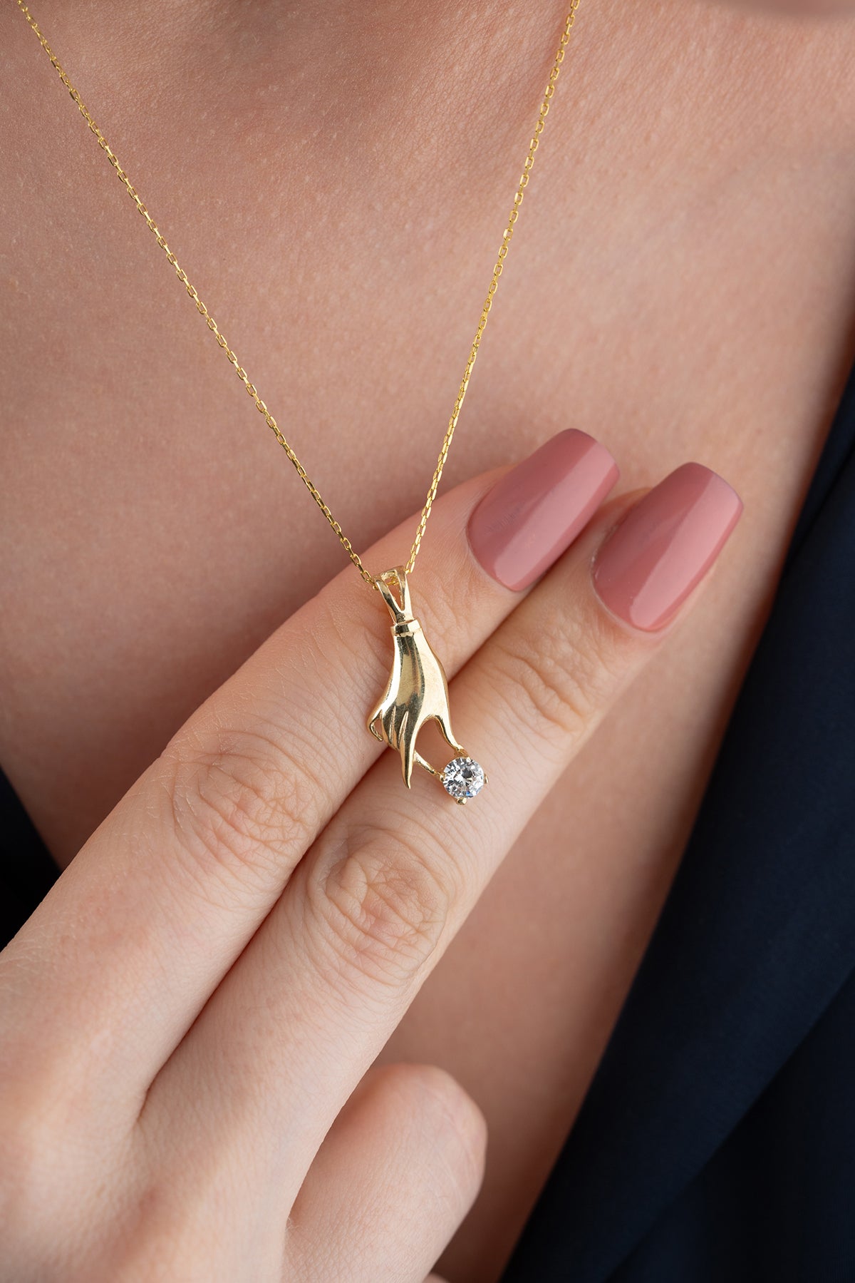 Hand Holding Stone Pendant Necklace