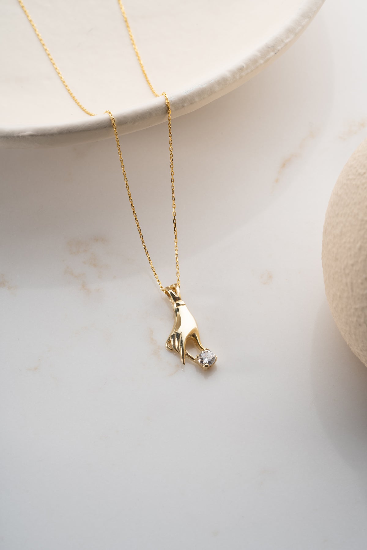 Hand Holding Stone Pendant Necklace