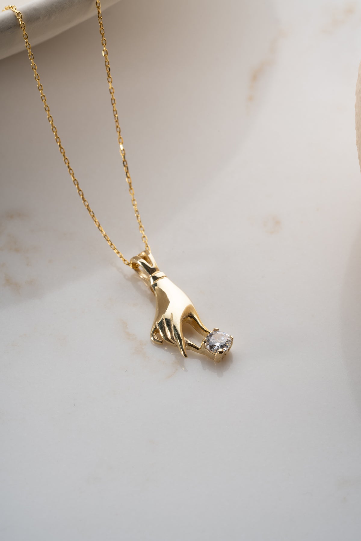 Hand Holding Stone Pendant Necklace